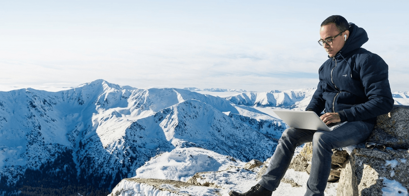 Person working remotely in the mountains